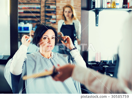 Upset woman in hairdress salon 30585759