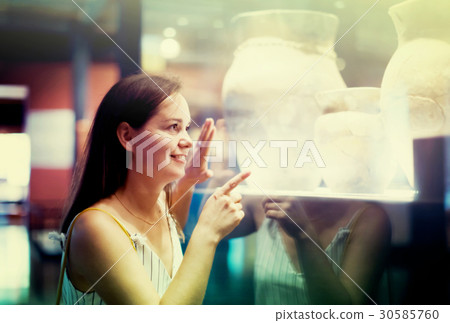 beautiful girl considers exhibits in museum beautiful girl considers exhibits in museum 30585760