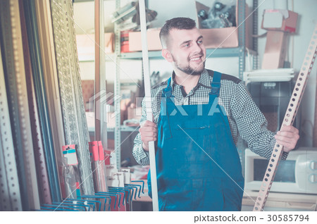 Production worker in uniform with plastic trim corners 30585794