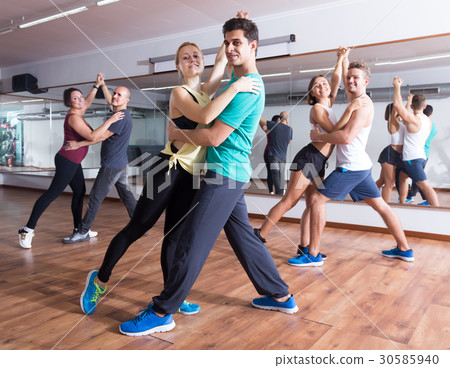 Friendly adults dancing bachata together Friendly adults dancing bachata together 30585940