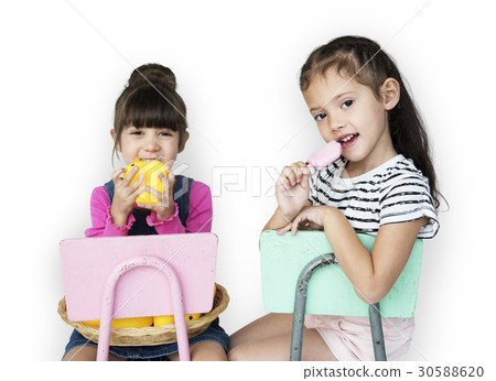Two young girls sitting on a chair portrait 30588620