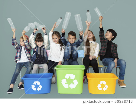 Kids and plastic bottles in a recycle bin 30588713