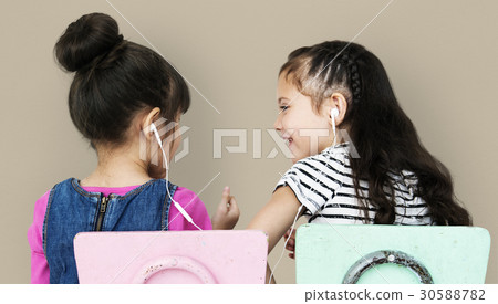 Rear view of two girls listening to music 30588782