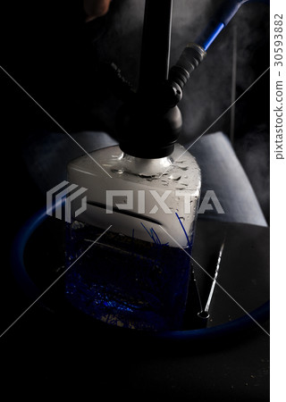 Man smokes fruit hookah 30593882