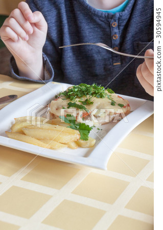 hands of the person eating the baked chicken hands of the person eating the baked chicken 30594945