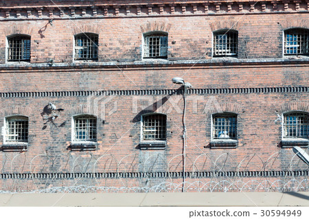 wall of prison with barred windows wall of prison with barred windows 30594949