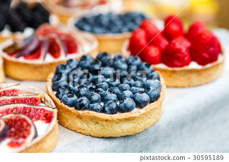 Closeup of blueberry tart dessert tray assorted 30595189