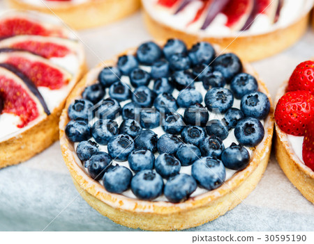 Closeup of blueberry tart dessert tray assorted 30595190