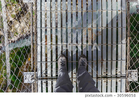 Suspension bridge in the mountains 30596058