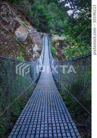 Suspension bridge in the mountains Suspension bridge in the mountains 30596215