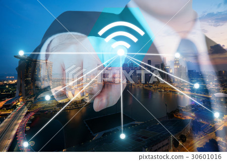 Businessman push wifi icon on city and network  30601016