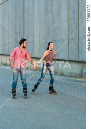 Woman and man rollerblading. Woman and man rollerblading. 30601201