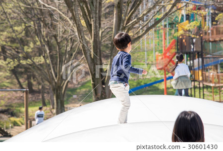 A boy playing in a park 30601430