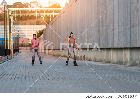 Couple is rollerblading. Couple is rollerblading. 30601637