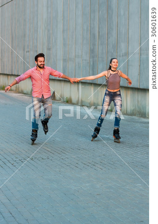 Man and woman rollerblading. Man and woman rollerblading. 30601639