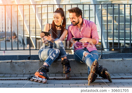 Smiling couple with cellphones. 30601705