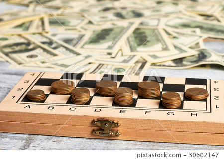 Stack of coins on chessboard. Stack of coins on chessboard. 30602147