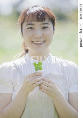 A woman with a four leaf clover A woman with a four leaf clover 30614614