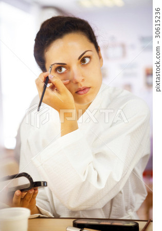 Close up portrait of a woman with eyebrow brush 30615236