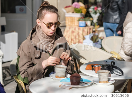 Woman with camera in outdoor cafe. Barcelona, Catalonia. Woman with camera in outdoor cafe. Barcelona, Catalonia. 30615606