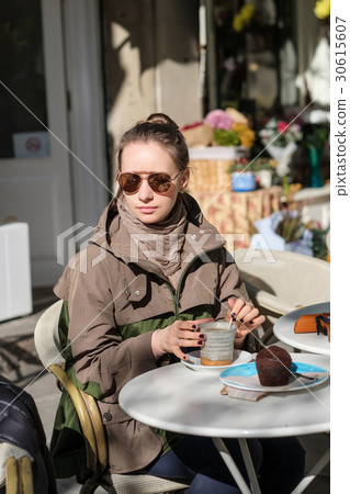 Woman with camera in outdoor cafe. Barcelona, Catalonia. Woman with camera in outdoor cafe. Barcelona, Catalonia. 30615607