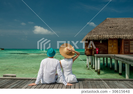 Couple on a beach jetty at Maldives 30615648