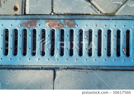 Static shot of storm drain in road 30617566