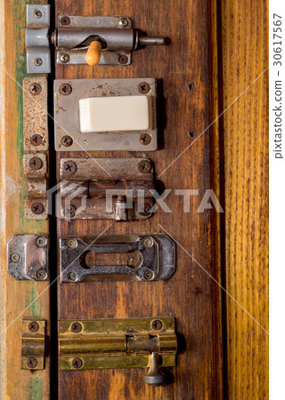 Door latches on wooden surface Door latches on wooden surface 30617567