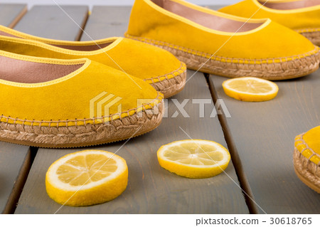Yellow espadrilles shoes near slices of lemon Yellow espadrilles shoes near slices of lemon 30618765