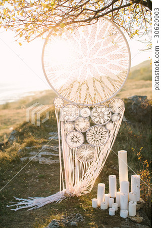 big white Dreamcatcher connected by a hook hanging 30620903