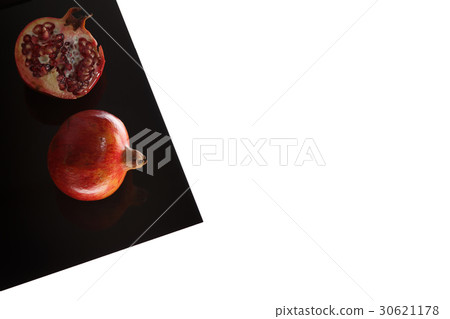 Granat Apple on Black Sheet Isolated on white 30621178