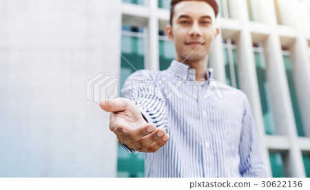 Open helping hand from young freindly businessman Open helping hand from young freindly businessman 30622136