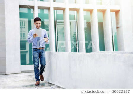 Happy Young Businessman use tablet while walk Happy Young Businessman use tablet while walk 30622137