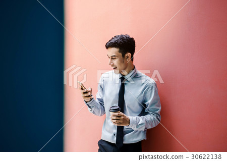 Happy Businessman use Smart phone and coffee Happy Businessman use Smart phone and coffee 30622138