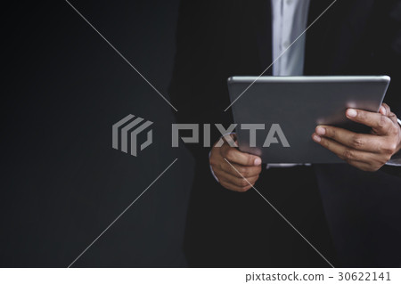 Part of Businessman using digital tablet,Dark tone Part of Businessman using digital tablet,Dark tone 30622141