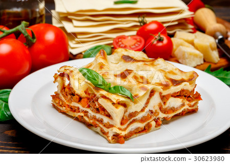 Portion of tasty lasagna on wooden backgound 30623980