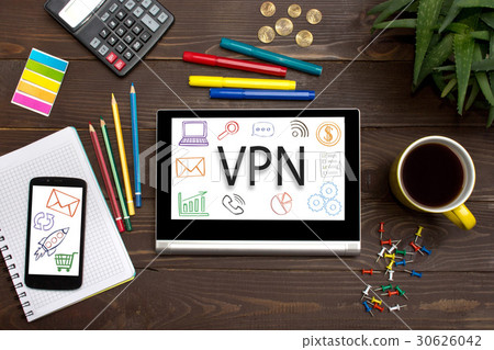Tablet with web icon VPN  on a wooden table  30626042