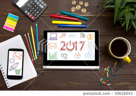 Tablet with web icon 2017   on a wooden table 30626043