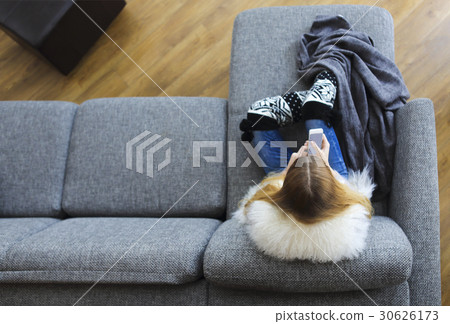 Woman writing a text message on her phone 30626173