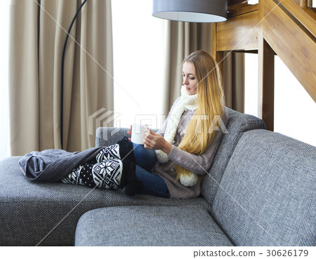 Blond woman relaxing on the sofa Blond woman relaxing on the sofa 30626179