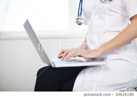 Female doctor working with laptop Female doctor working with laptop 30626186