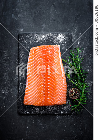 Raw salmon filet on dark slate background Raw salmon filet on dark slate background 30626196
