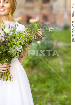 Beautiful wedding bouquet in brides hands 30626246