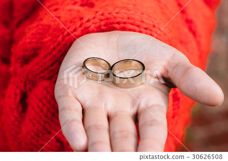 Two wedding rings in a hand of the bride Two wedding rings in a hand of the bride 30626508