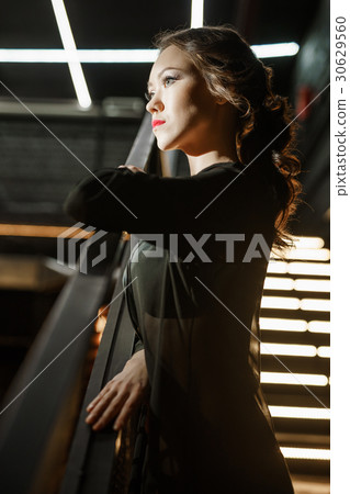 Sexy woman in black leather belts and silk gown Sexy woman in black leather belts and silk gown 30629560