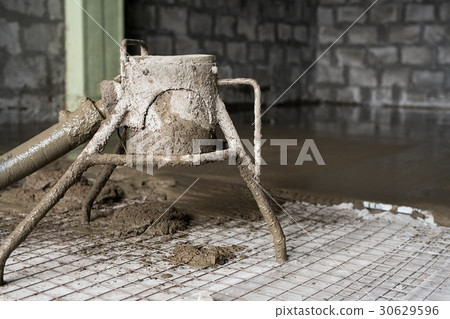 Making cement screed on the floor view 30629596