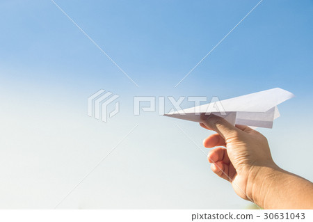 Hand holding rocket paper with blue sky. concept f 30631043