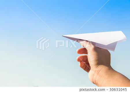 Hand holding rocket paper with blue sky. concept f 30631045