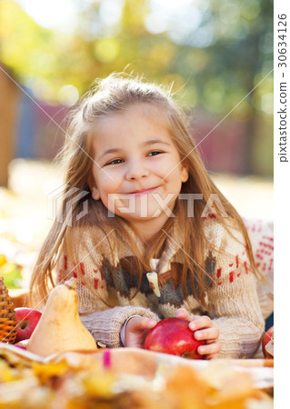 Adorable little girl with autumn leaves and apple Adorable little girl with autumn leaves and apple 30634126