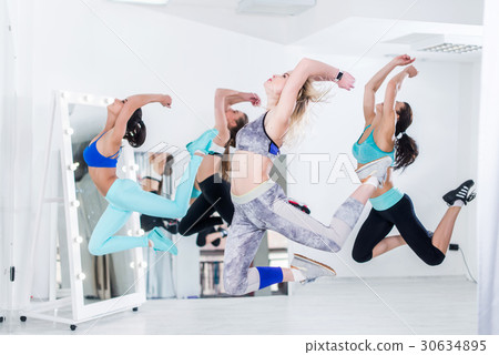 A group of slim fit athletic young women doing A group of slim fit athletic young women doing 30634895